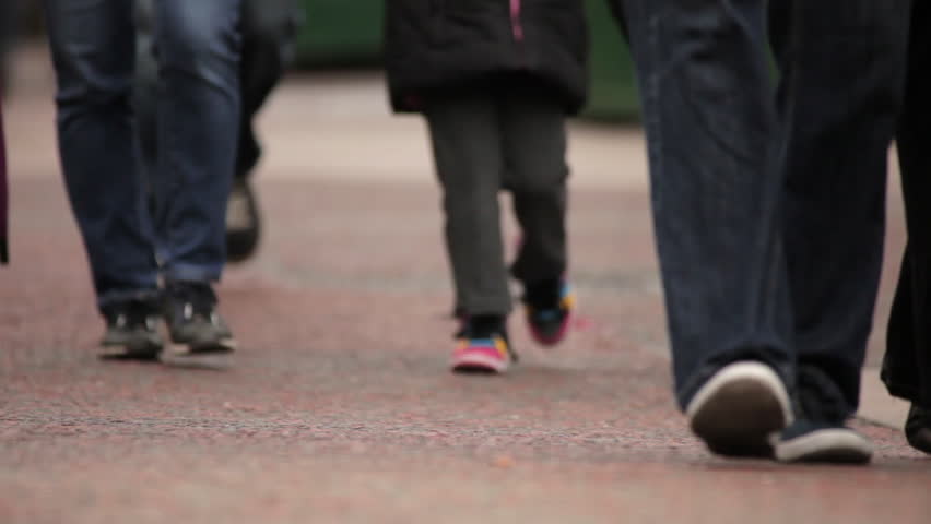 Unidentified people's legs and feet as they walk in London