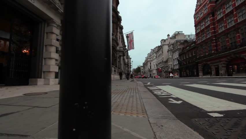 Low angle slider shot looking down a street and crosswalk in London