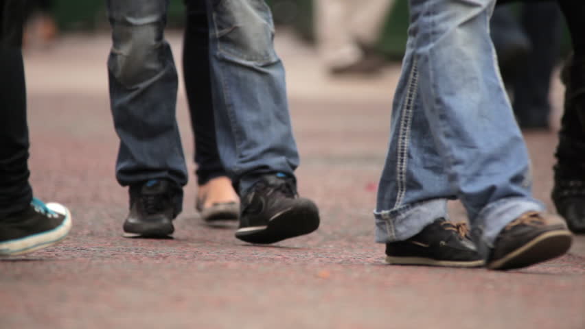 Legs and feet of unidentified people walking in London
