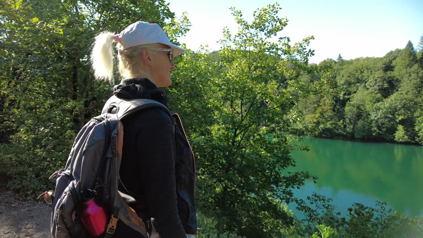 Proscansko Lake Proscansko Jezero viewpoint: backpacker woman in the Plitvice Lakes National Park of Croatia. Natural forest park with lakes and waterfalls in Lika region. UNESCO World Heritage site