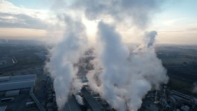 Aerial video documentation of a factory releasing water vapor into the air 