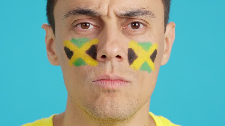 Close up of a man supporting jamaican team