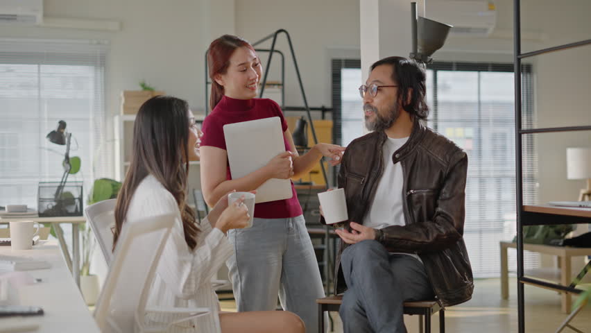 Asian Friendly happy diverse team workers talking laughing drinking coffee together in office,cheerful workers staff group chatting sharing story enjoying having fun at work,good relations at break Royalty-Free Stock Footage #3441131847