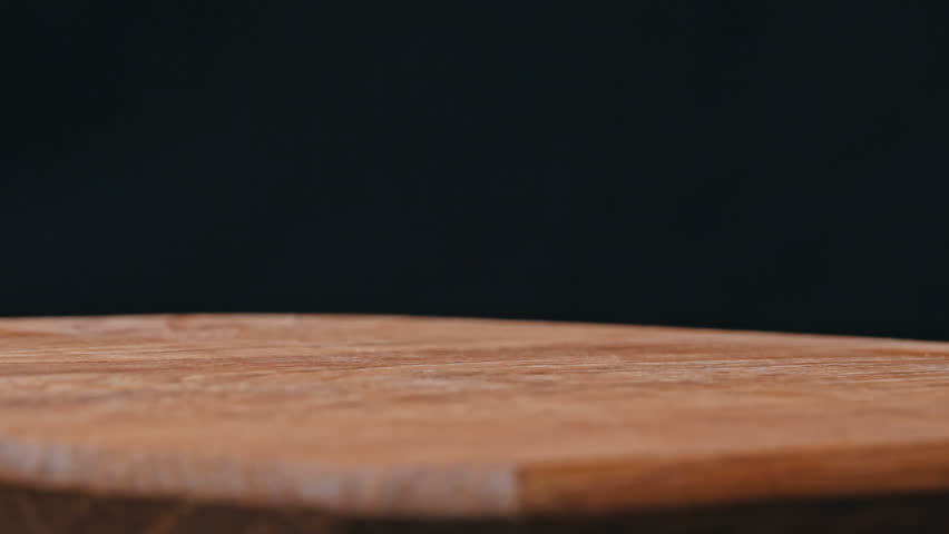 Craft potato chips fall in slow motion on a wooden plate. Junk food. Potato snack for unhealthy fast food. Unhealthy lifestyle and fast carbohydrates.