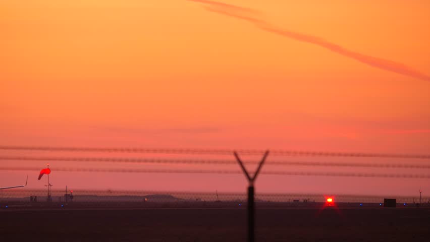 Twin jet engine plane taking off in silhouette against an orange sky sunset from LAX airport with sound. Royalty-Free Stock Footage #34412206