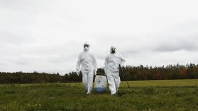 Two man in protective suit carrying dangerous chemical
