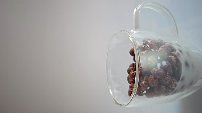 Chocolate cereal, chocolate cereal falling into a glass cup, vertical video, selective focus, 4k. Royalty-Free Stock Footage #3441250259