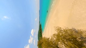 Vertical video. Cinematic FPV drone flight over tropical white sandy beach and turquoise sea on paradise island in Thailand.
