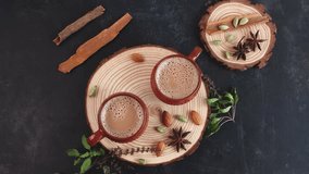 Pouring Indian Masala Chai traditional beverage tea with milk and spices in Kerala India Sri Lanka. Two cups of organic tea. Ayurvedic herbal drink good for winter immunity boosting.