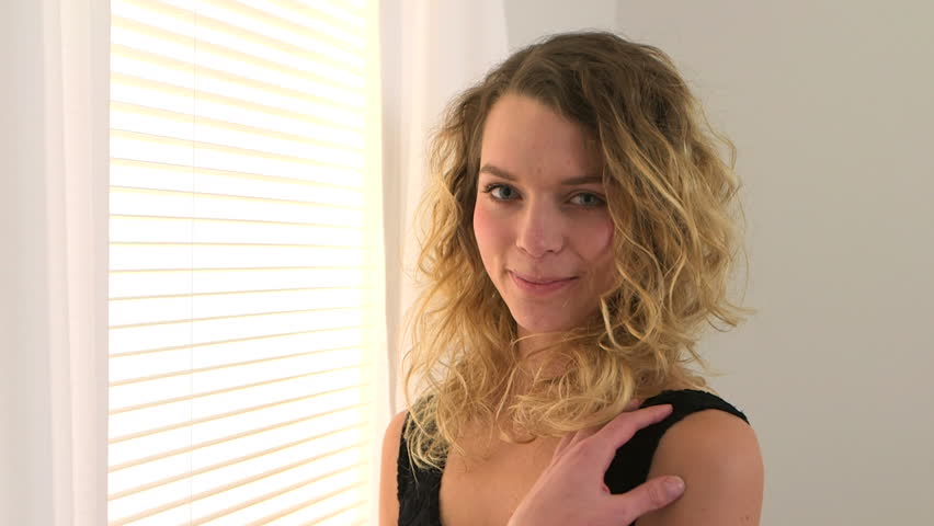 Happy blonde woman with curly hair