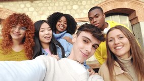 Cool millennials taking a selfie with friends outdoors