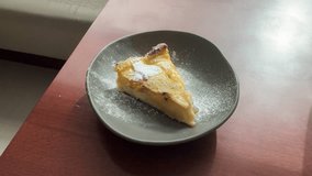 Delicious Apple Tart Slice. Tempting Glazed Pastry Dessert over Wooden Table. Handheld close up footage