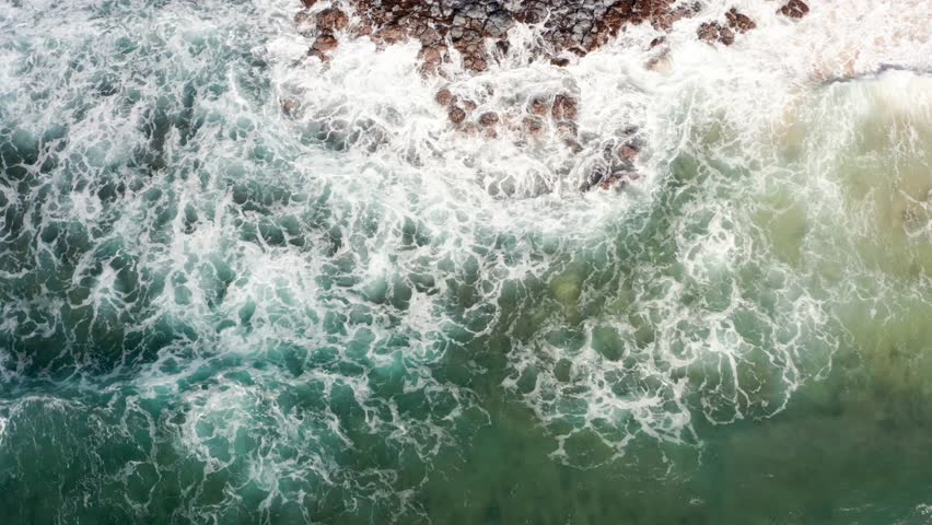 Overhead View Of Ocean Waves Crashing On rock formations and beach in hawaii Royalty-Free Stock Footage #3441434251