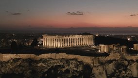 Aerial video at sunset over the Acropolis, a UNESCO World Heritage Site, Athens, Greece