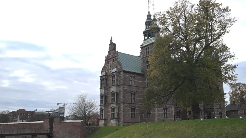 The city of Copenhagen on a beautiful sunny day, including ducks in a pond.