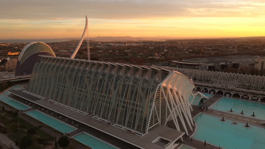 Golden sunset light bathes the modern architectural marvel in Valencia, as seen from an aerial drone view. The urban atmosphere is serene and majestic. Camera 4K RAW.  Royalty-Free Stock Footage #3441563813