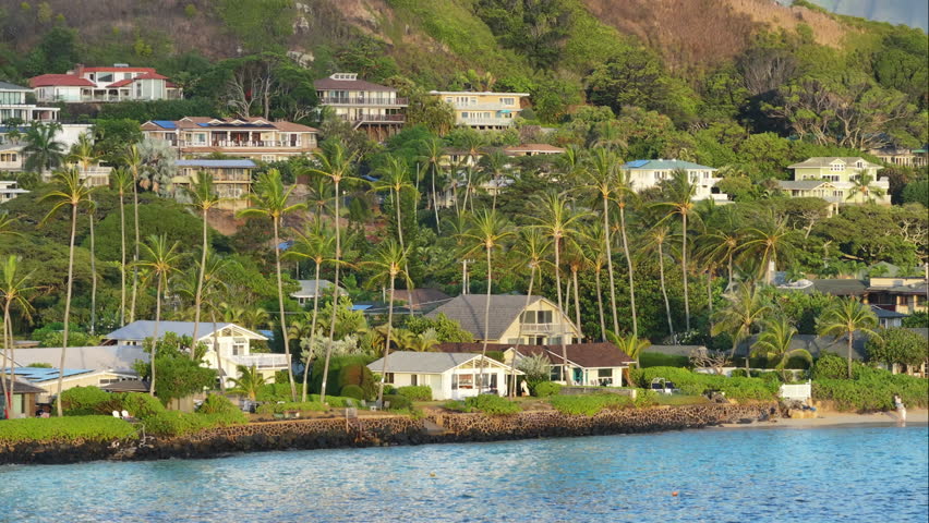 Real estate property on tropical island. Home rentals in Kailua town mountains background. Estate business with luxury beach villas and cottages for sale. Lanikai beach a peaceful place on Oahu Hawaii