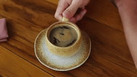 Hot Americano on a wooden table. Coffee break video.