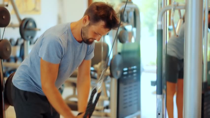 Multi-gym Sport Workout.Chest Workout Pull Down Machine. Sport Recreation Bodybuilding Lifting Weight. Fitness Exercising Sport Gym. Triceps Pushdown. Weight Lifted Exercising In Gym Pull Down Machine Royalty-Free Stock Footage #3441634251