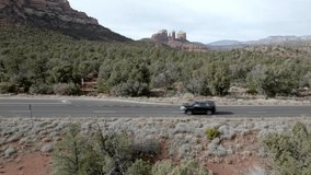 Red rock mountains and buttes in Sedona, Arizona with drone video moving sideways close up.