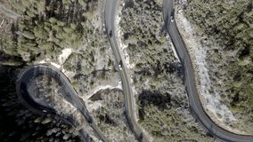Switchback road with cars driving on Highway 89 A in Sedona, Arizona with drone video overhead moving down.