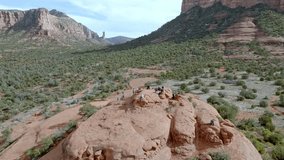 Buttes in Sedona, Arizona with people on top and drone video moving in a circle.