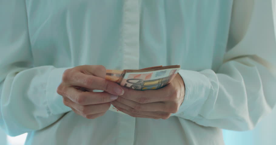 Female hands calculating euro cash, close-up shot. Unknown worker counting money savings for purchase