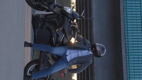 A Caucasian man in a helmet rides an electric motorcycle.