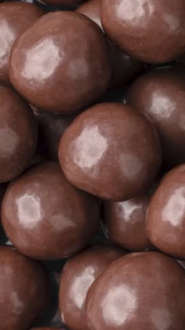 Vertical video. Closeup of chocolate malted balls. Candy backdrop. Royalty-Free Stock Footage #3441941961