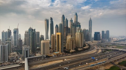Fantastic skyline of Dubai Marina. Scenic elevated view over skyscrapers and highways at daytime. 4K time lapse. 
