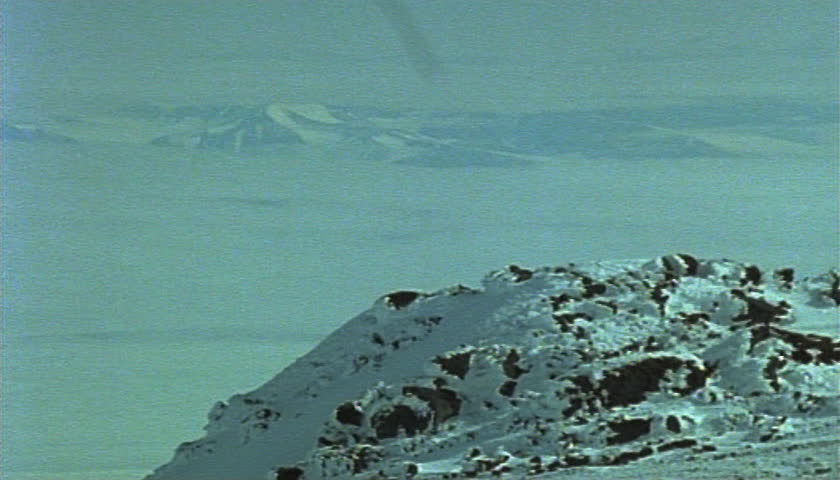 Visitors climbing over snowy terrain