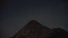 Stunning night eruption: Fuego Volcano spews lava into the sky, ash plume rises with stars in sky filmed from Acatenango camp - Powered by Shutterstock - Get 15% off with code: PIKWIZARD15