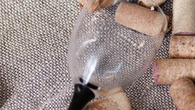 close-up of an overturned empty glass and wine bottle corks on a textured fabric rotation. wine tasting, wine production, alcoholism concept - Powered by Shutterstock - Get 15% off with code: PIKWIZARD15