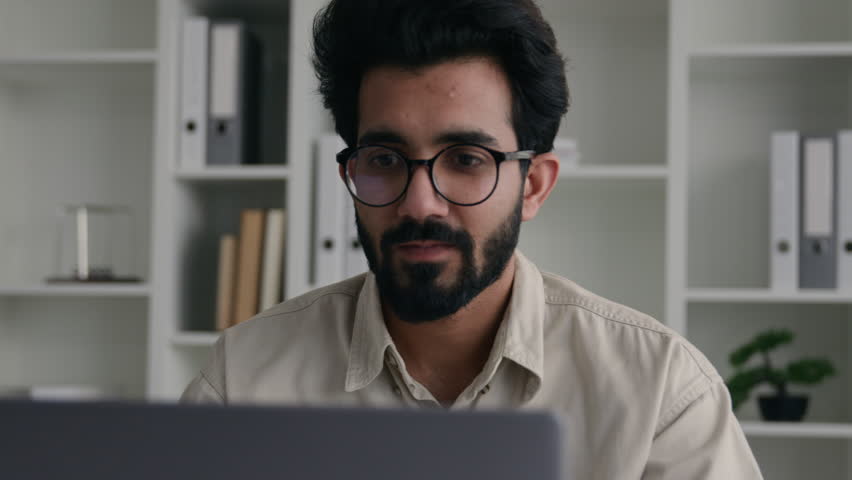 Upset disappointed Indian muslim guy businessman male entrepreneur stressed frustrated Arabian business man looking at laptop pc at office stress problem fail with computer money loss bankrupt failure Royalty-Free Stock Footage #3442058547