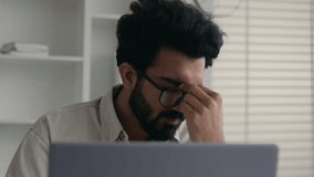 Upset disappointed Indian muslim guy businessman male entrepreneur stressed frustrated Arabian business man looking at laptop pc at office stress problem fail with computer money loss bankrupt failure - Powered by Shutterstock - Get 15% off with code: PIKWIZARD15