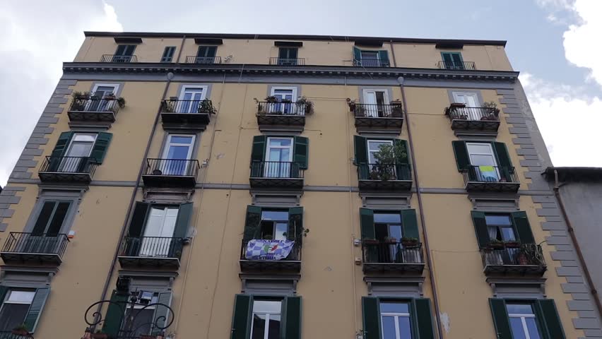 Residential apartment block facade with small window balconies Naples Italy LOW ANGLE
