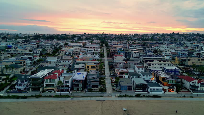 Aerial tracking shot of the Manhattan Beach district, sunset in Los Angeles, USA