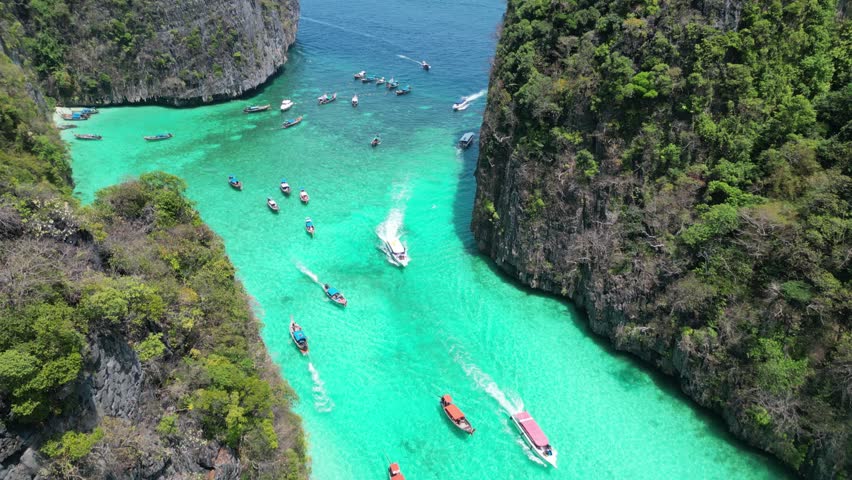 Boats entering scenic Pileh Lagoon of Phi phi island, Aerial Royalty-Free Stock Footage #3442112049