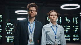 Serious technicians couple posing in modular datacenter portrait. IT administrators coworkers looking camera at network storage server room closeup. Engineers colleagues in operative modern cabinet  - Powered by Shutterstock - Get 15% off with code: PIKWIZARD15