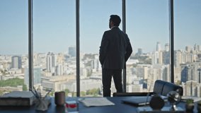 Nervous manager walking office room rear view. Pensive businessman looking city making company decision at panoramic window. Successful ceo expert think enjoy silent break. Corporate leader silhouette - Powered by Shutterstock - Get 15% off with code: PIKWIZARD15
