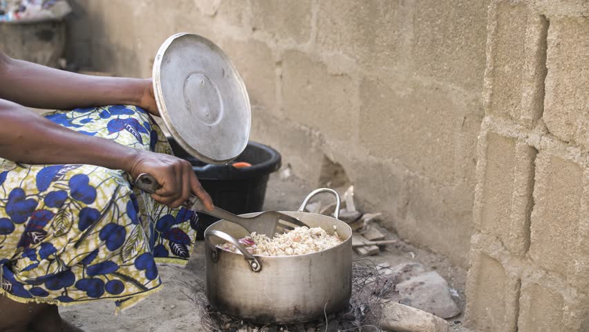 24th December 2023,gwalada Nigeria:African women preparing local traditional meal in a rural area.rustic pot on open fire cooking hot food.traditional cooking stove with wood