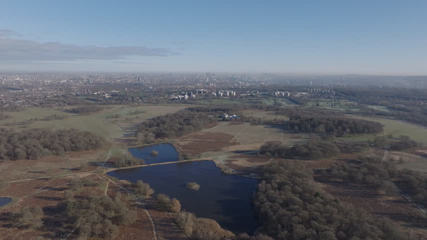 Aerial shot over Richmond park in the winter towards central London