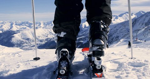 Skier Attaching Ski Boots And Skiing - Back View 4K