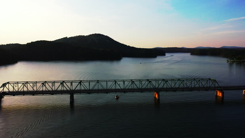 Romantic view of truss bridge over water surface at twilight. Evening scenery with Lake Allatoona. Atlanta, Georgia, USA