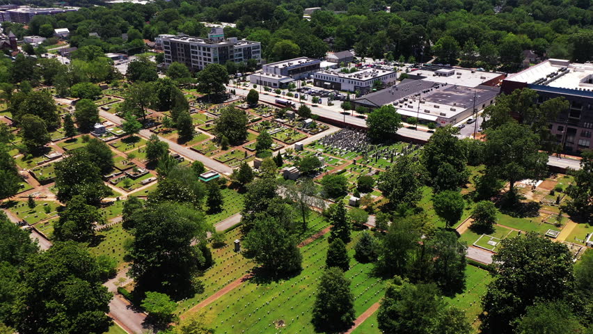 High angle view of town cemetery. Rows of tombstones in green lawn. Calm place of final resting. Atlanta, Georgia, USA Royalty-Free Stock Footage #3442265661