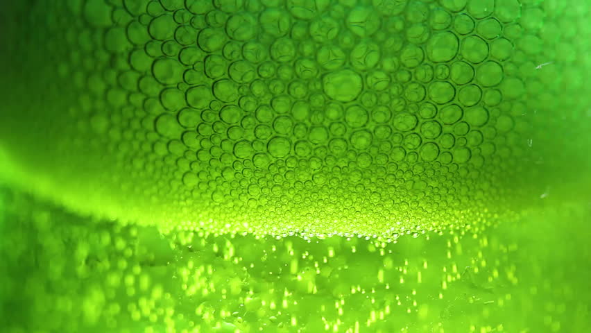 Bubbles in green glass of beer close up macro. Royalty-Free Stock Footage #34423246