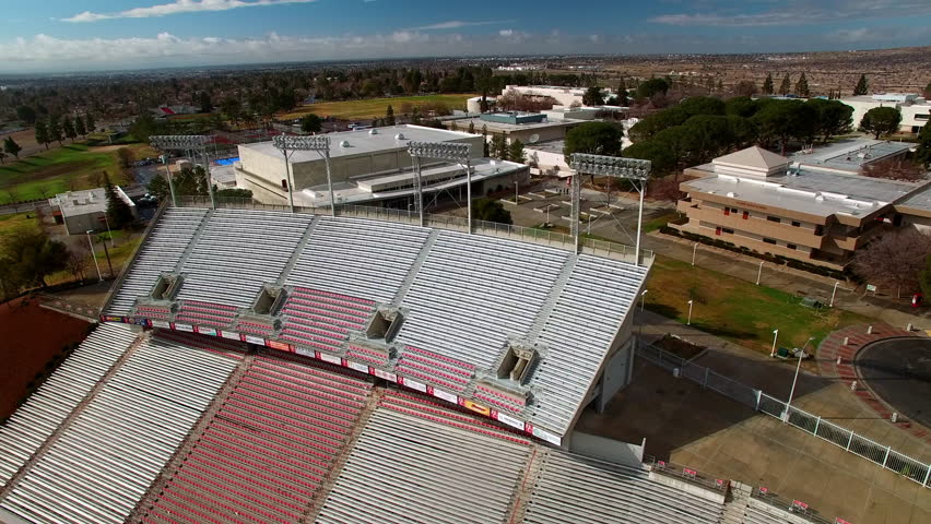 Aerial Panning Shot Of Empty Bleachers Of Memorial Stadium In City On Sunny Day - Bakersfield, California