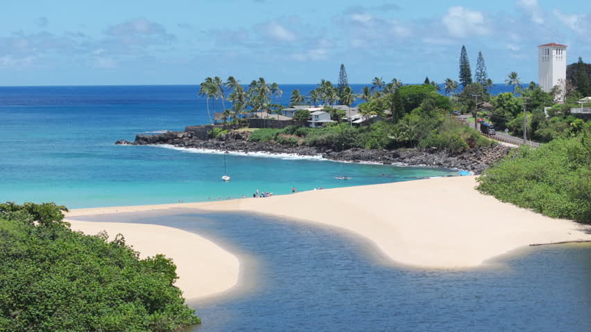 Scenic nature landscape of Hawaii island. Waimea Valley panorama on Oahu North shore USA travel. Cinematic aerial Waimea Bay Beach on sunny summer day. People enjoy vacation on beautiful sandy beach