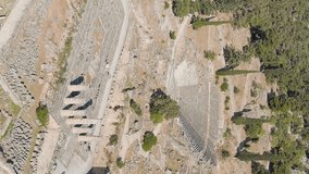 Vertical video. Delphi, Greece. Ruins of the ancient city of Delphi. Sunny weather in the morning, Summer, Aerial View, Point of interest