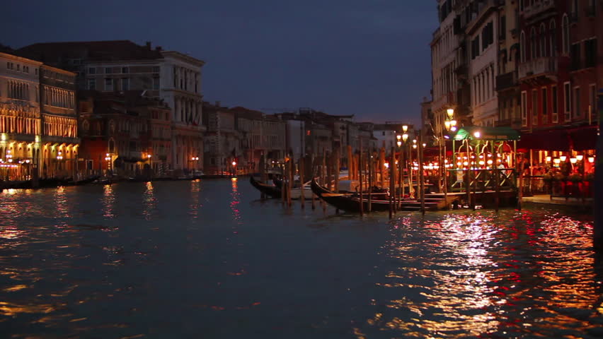 Floating by low lit buildings at night in Venice Italy